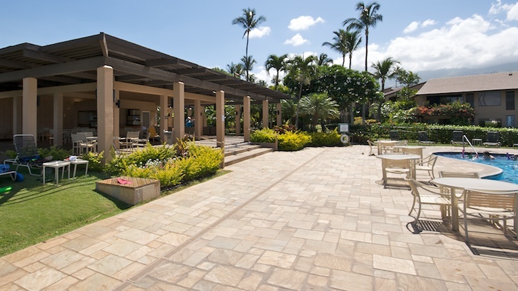 Pool deck with nearby pavilion offers shade and relaxation